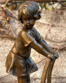 Бронзовые статуи маленькой девочки в платье на табурете