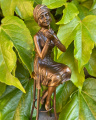 Статуя женщины красится на стуле из бронзы